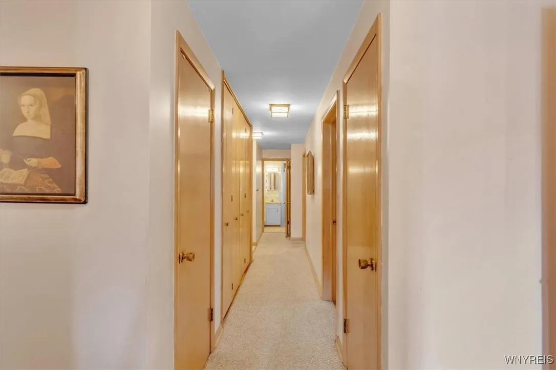 This long hall way leads to the next two bedrooms There is a large closet off to the left behind the bifold doors