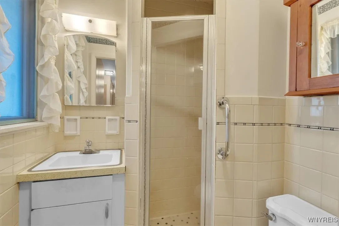 Here is the second of the 2 full bathrooms in the home. . This compact room has it all including a walk in shower