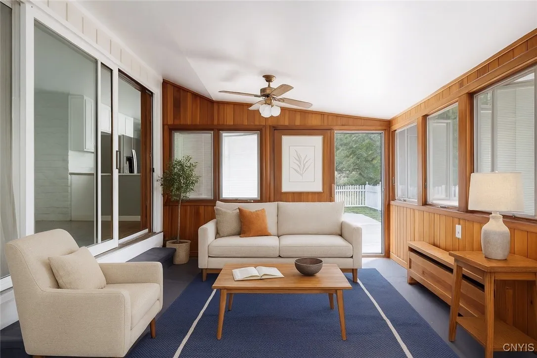 This photo of the sunporch has been virtually staged. How cute
