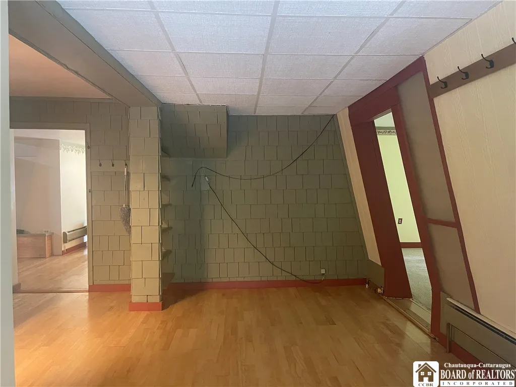 Open area by laundry room and behind living room, lower deck is off this room, room to right is the family room