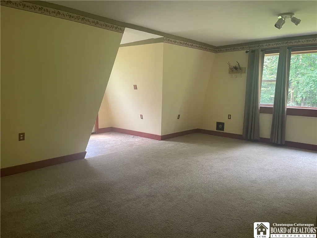 Family room with back entrance door and window to back woods
