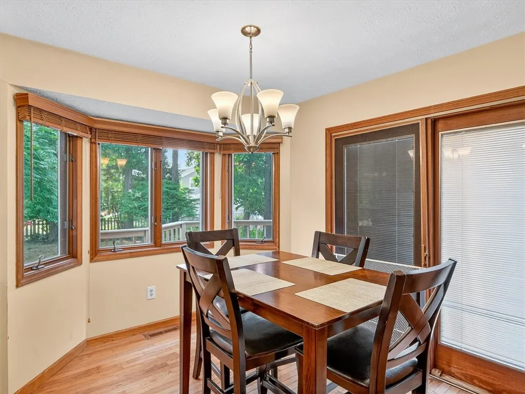 Bow Window & Sliding Glass Doors To The Backyard