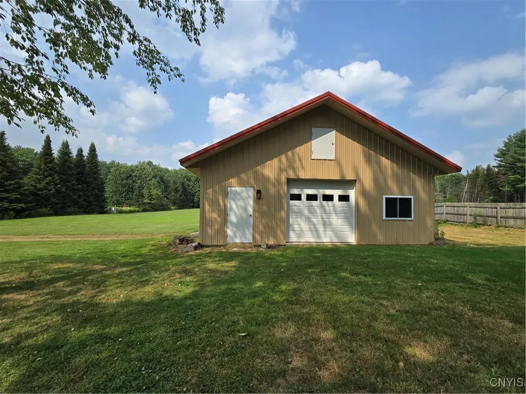 Here's the infamous pole barn measuring 30' by 30' and offering 3 overhead doors, a regular door and a hay/storage door on the upper floor.