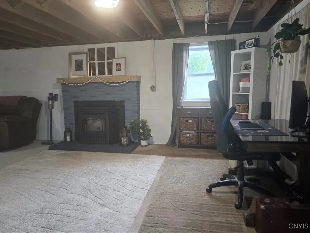 The new Quadrafire Trekker Series Pellet stove insert brings warmth to the lower level--both in heat as 
well as ambience. A new mantel was also purchased for this fireplace.