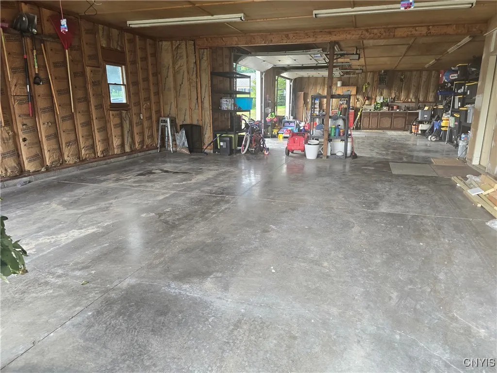 This 4 car heated garage has 2 wash bays (front 2 have drains) and plenty of room to store your vehicles and toys. There's also a workbench/area.
