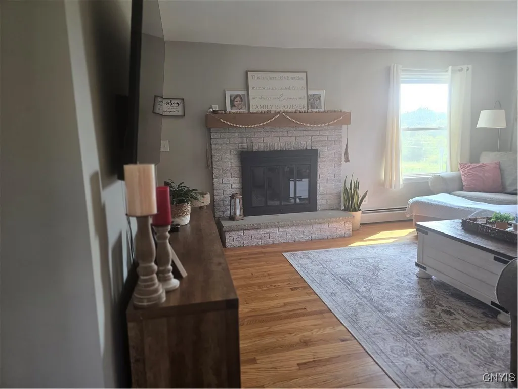 The fabulous family room is highlighted by the beautiful woodburning fireplace, hardwood floors and plenty of light!