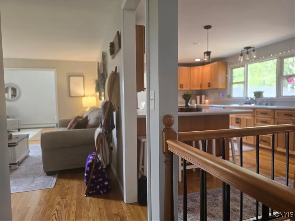 The wood & wrought iron railing add style as well as convenience to this home. It opens the room up, brings light throughout and gives it a new look.