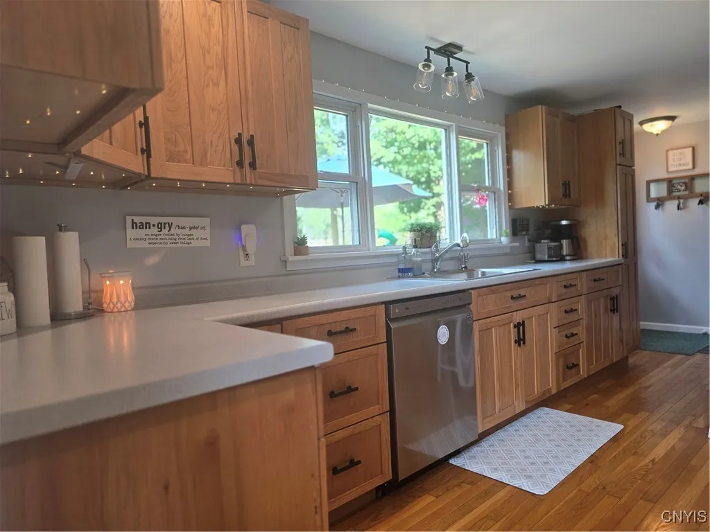 The three windows above the sink allow sunlight to come in and bring the beautiful yard to your eyes! The cabinets, counters and decor complete the tranquil setting.