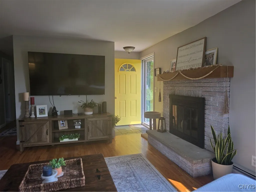 The front door adds light and style to the foyer. The new mantel accents the fireplace well.