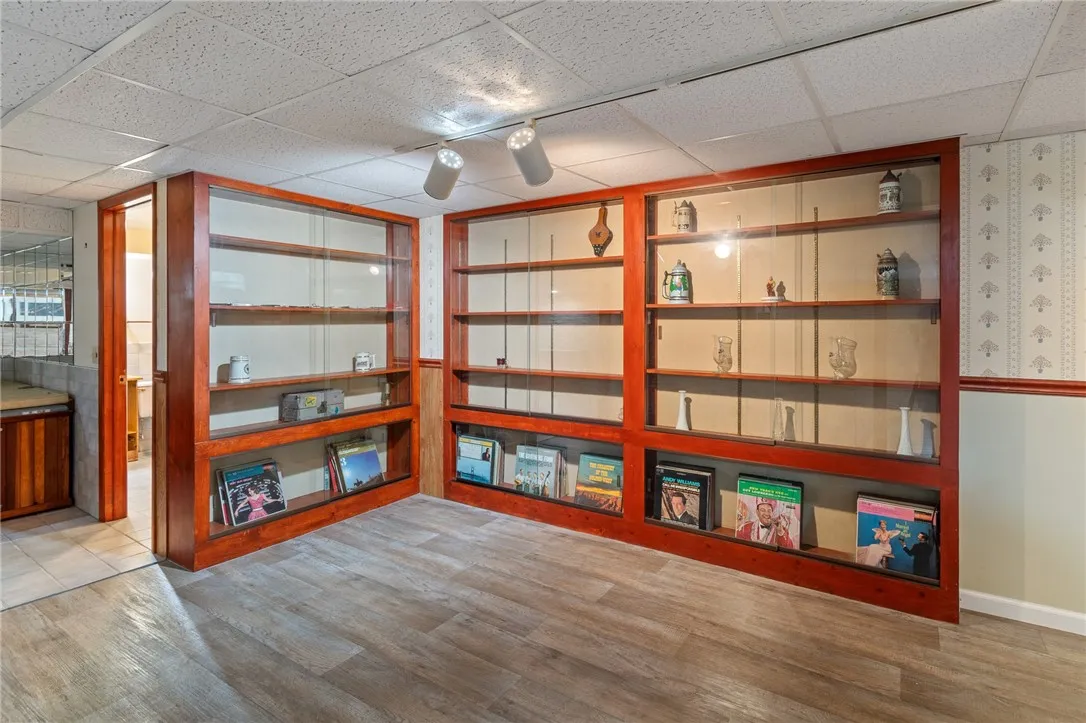The LOWER LEVEL BUILT IN SHELVING - display all your memorabilia and treasures! Note the HOT TUB in the alcove next to the FULL BATH