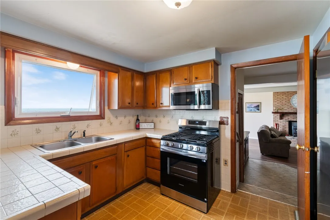 The kitchen- opens to the HUGE family room - all the front rooms have views of the WATERFRONT!