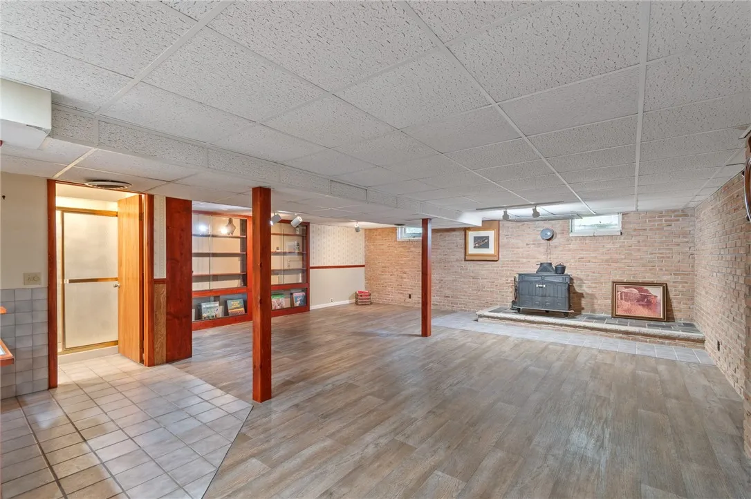 What a MASSIVE entertainment space! DANCE THE NIGHT AWAY! There’s a wood burner to keep it cozy! A FULL BATH- a KITCHENETTE- a HOT TUB room AND ANOTHER FULL BATH! There’s even adjacent laundry as well!