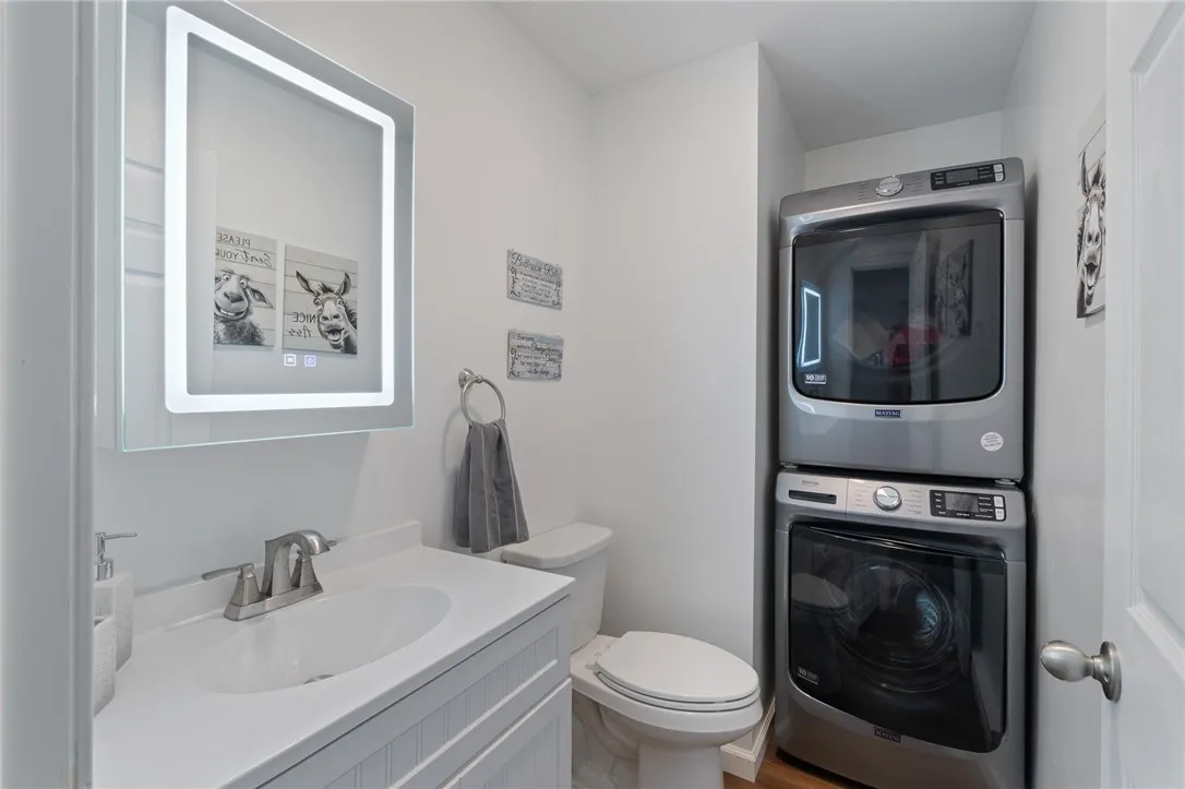 The HALF BATH/LAUNDRY ROOM, located off the HUGE gathering room with a view of the Lake as well!