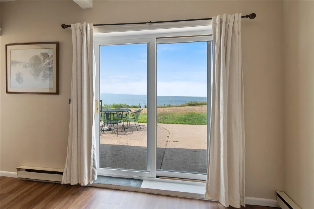 The view from the family room to the waterfront and the concrete patio