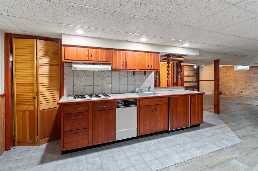 The LOWER LEVEL ENTERTAINMENT AREA- there’s a FULL BATH- a WOOD STOVE- -a HOT TUB and so much more!