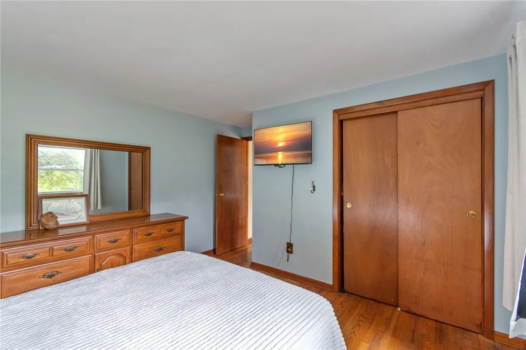 The PRIMARY BEDROOM- hardwoods and a place for your flat screen TV!