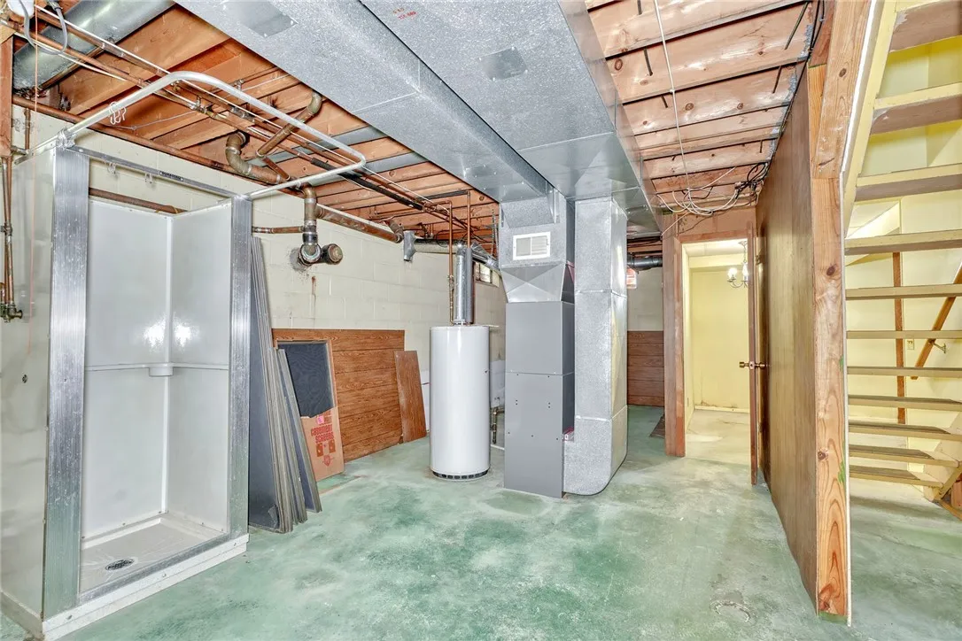 Storage area of the basement with bonus shower stall!