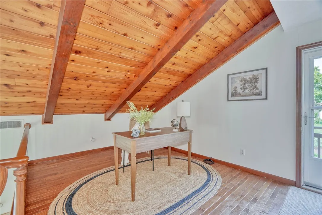 Open Loft with Pegged hardwoods overlooking the family room. Door Leads out to balcony/deck.