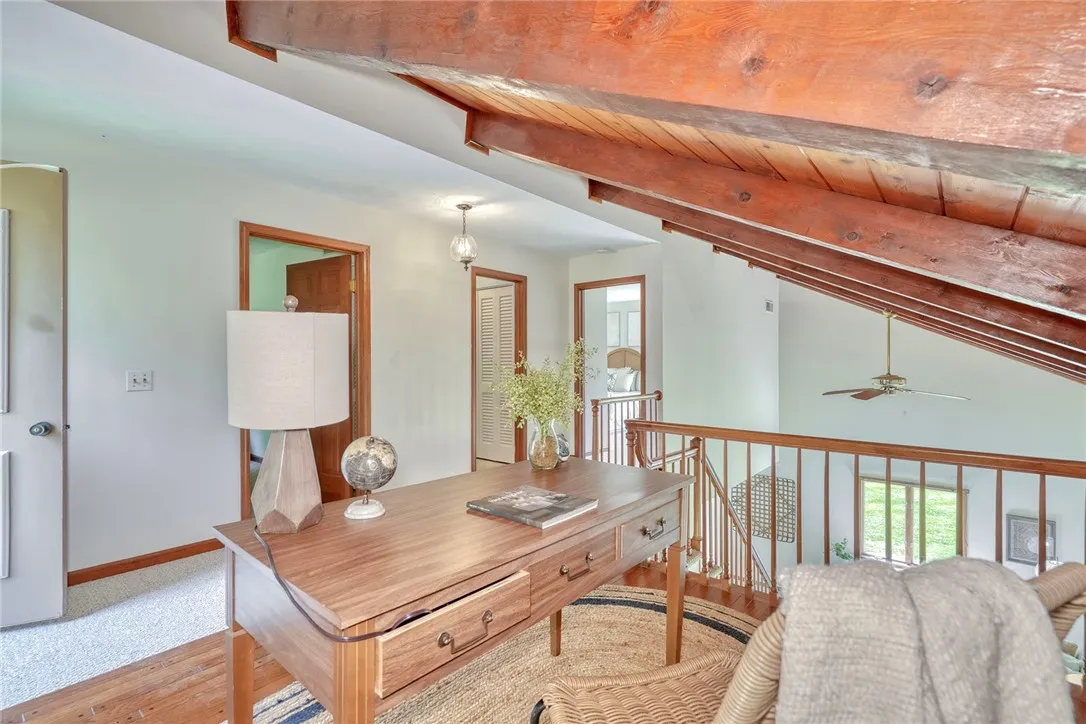Open Loft with Pegged hardwoods overlooking the family room. Door Leads out to balcony/deck.