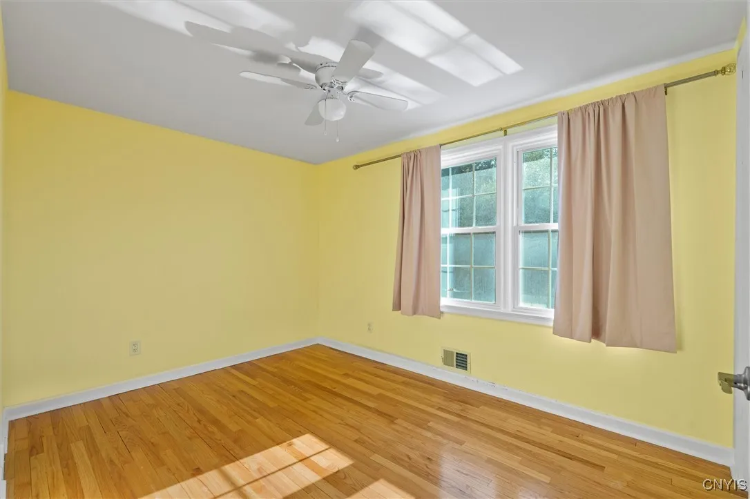spacious second bedroom with new lighted ceiling fan
