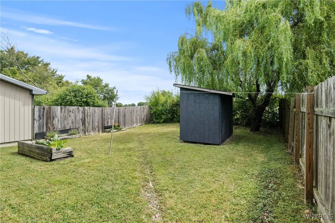 Backyard behind house showing second fenced in area behind garage, that was used for dog let out. Backyard behind house showing second fenced in area behind garage, that was used for dog let out.