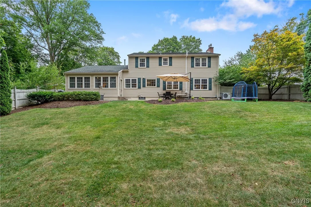 Fully Fenced in Yard with large patio - another seating area is just behind the bushes on the left
