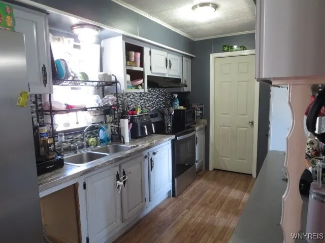 Kitchen with stove & refrigerator only 2 yrs young, & microwave included - all AS IS...
