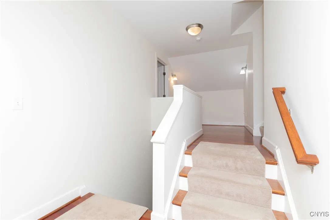 Stairway down to the mudroom and up to the bonus room, on the left.  To the right is the long hallway to the other bedrooms.