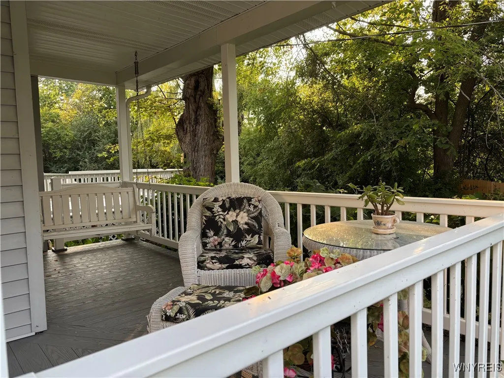 Wonderful wraparound covered porch features trex decking & porch swing!