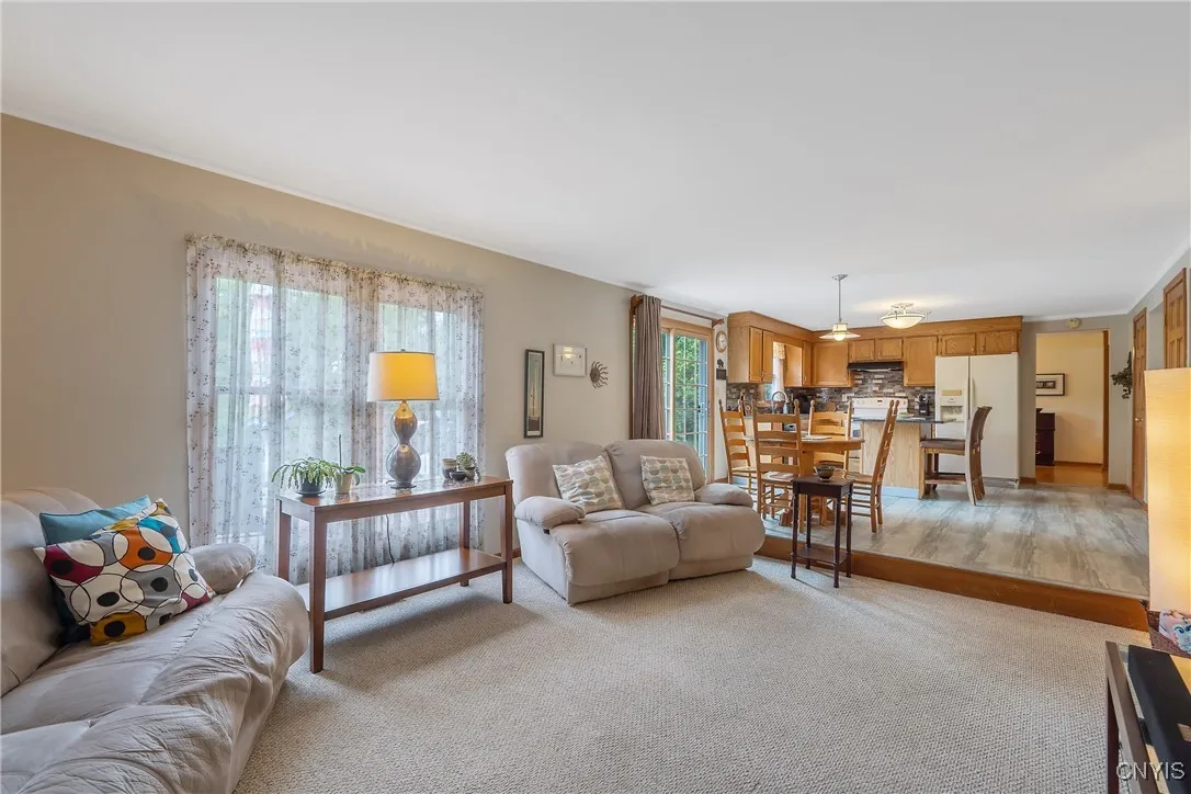 From the eat-in kitchen, we take a step down into the family room. Newly painted walls & ceiling frame this quite spacious room.  The layout lends itself to a number of options for furniture and/or television placement.