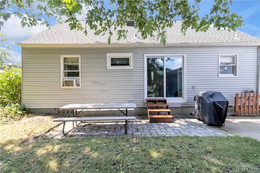 Sliding door from kitchen to backyard with small patio.
