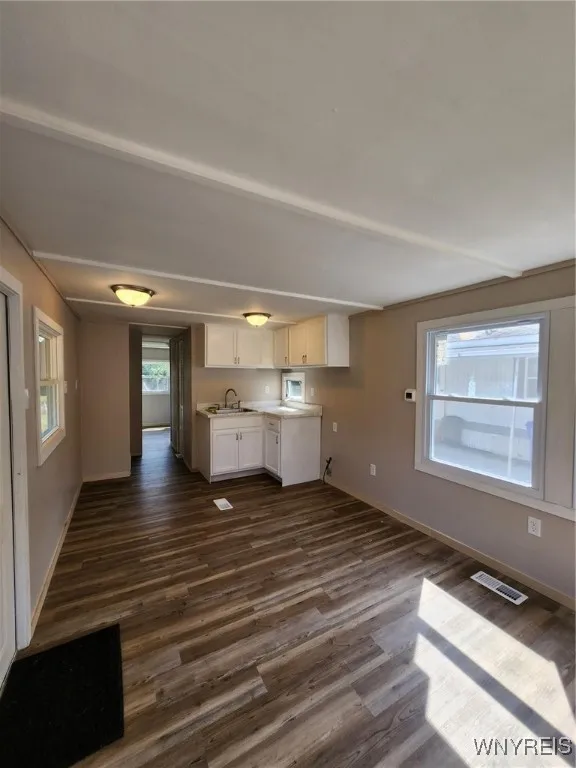 Livingroom area with view of hallway to bedroom