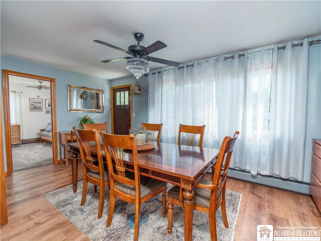 Formal dining room with new flooring, a new door, new lighting and fully furnished minus the two side cabinets