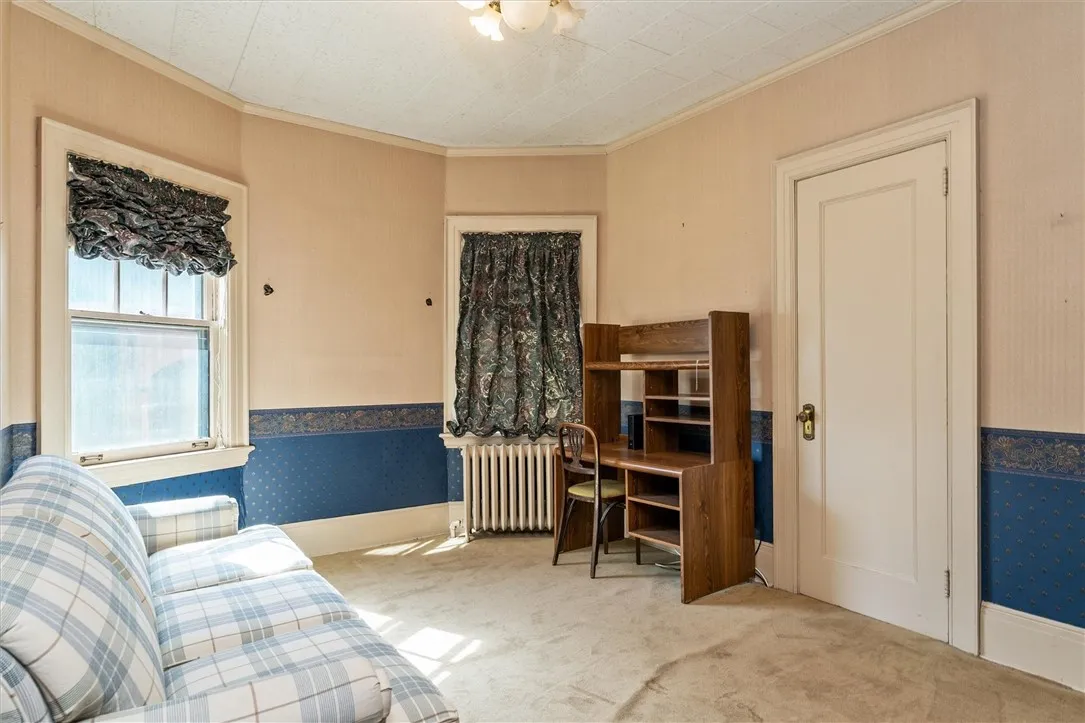Unit 1: Bedroom #1 with carpet over hardwood floors