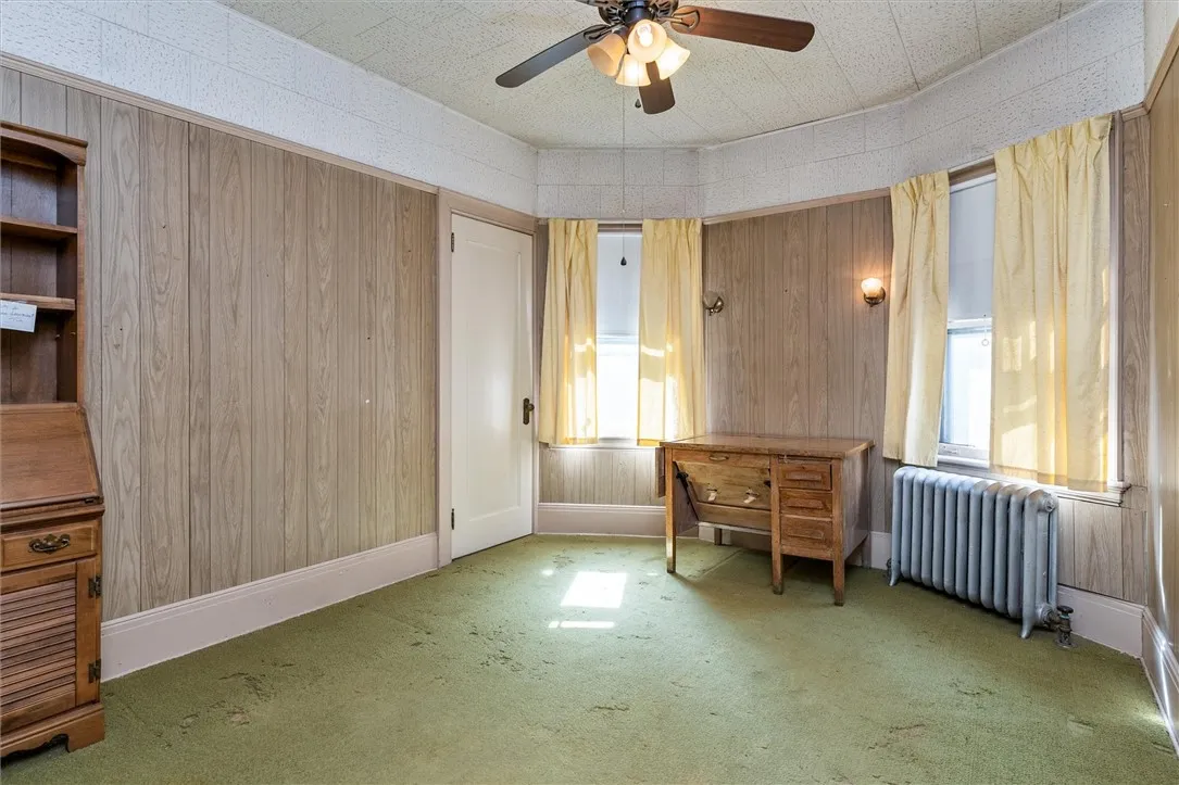 Unit 1: Bedroom #2 with carpet over hardwood floors