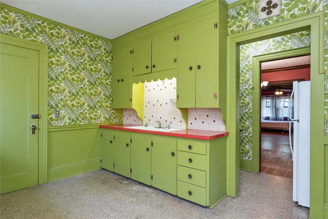 Eat-in Kitchen in Unit 2 with painted wood cabinetry