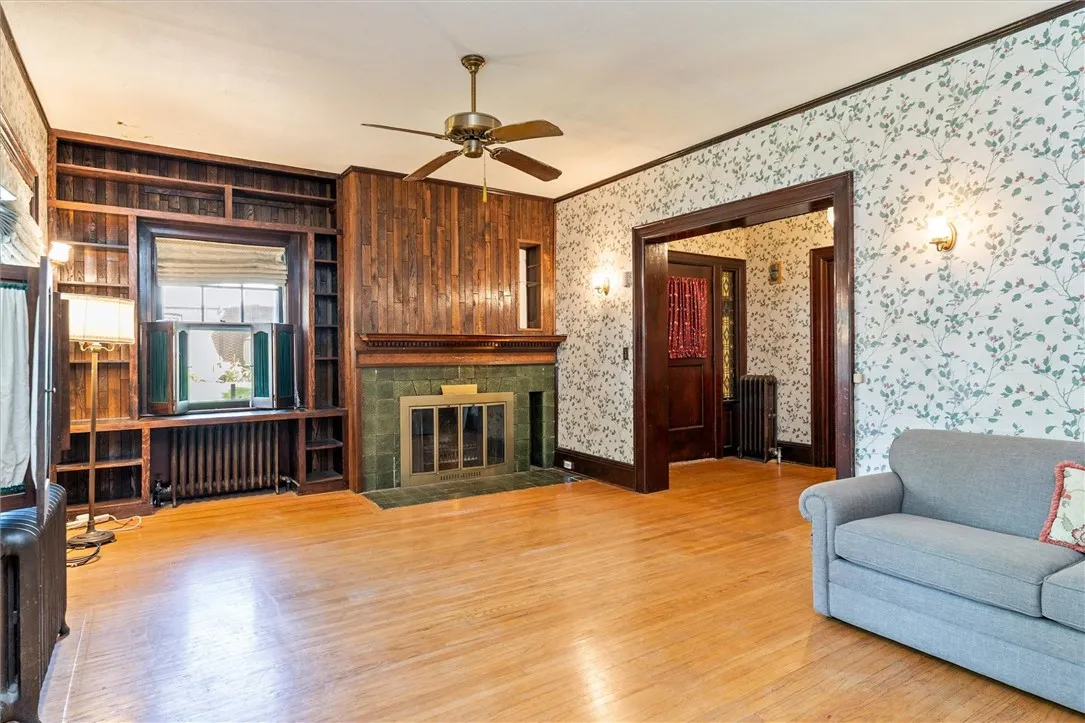 Woodburning fireplace in Living Room with built-in bookcase