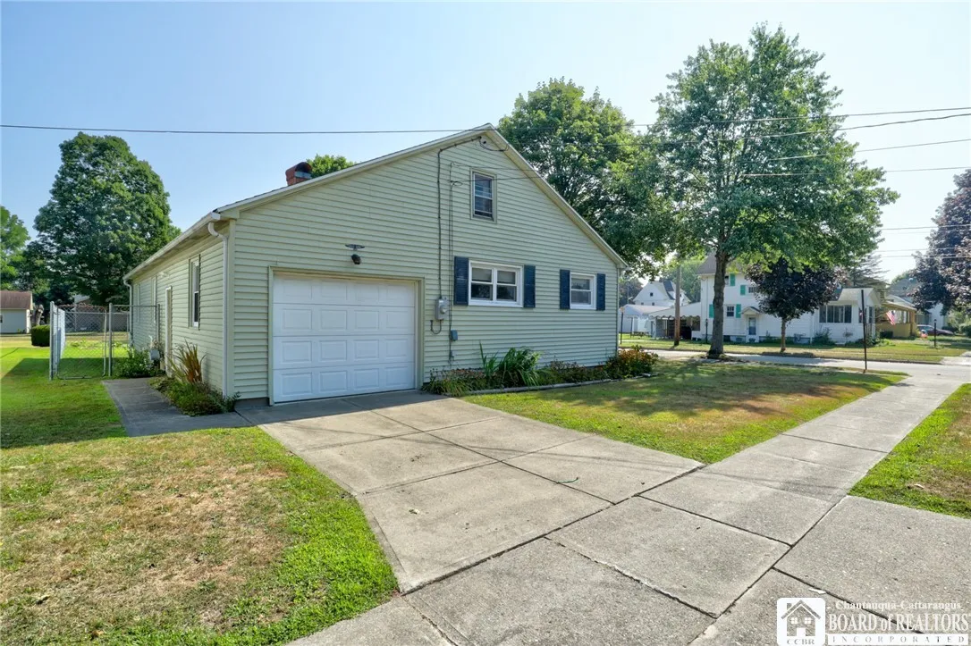 Cement driveway to the attached garage