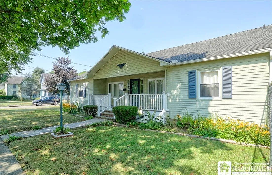 Lovely covered front porch...vinyl sided