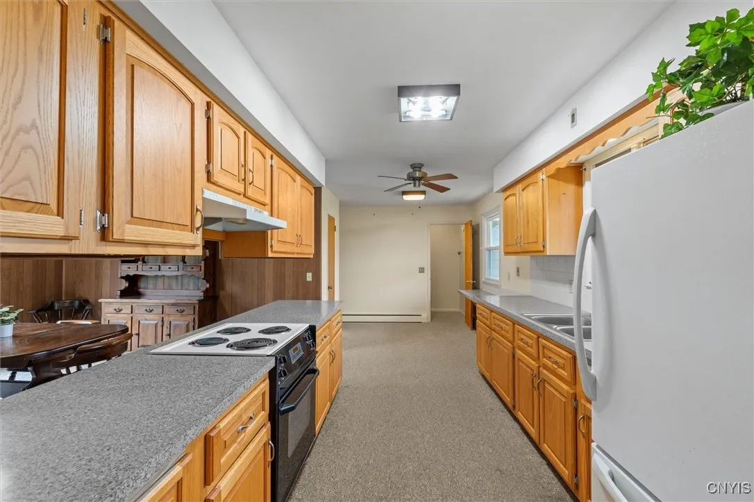 Galley kitchen leads to garage and basement