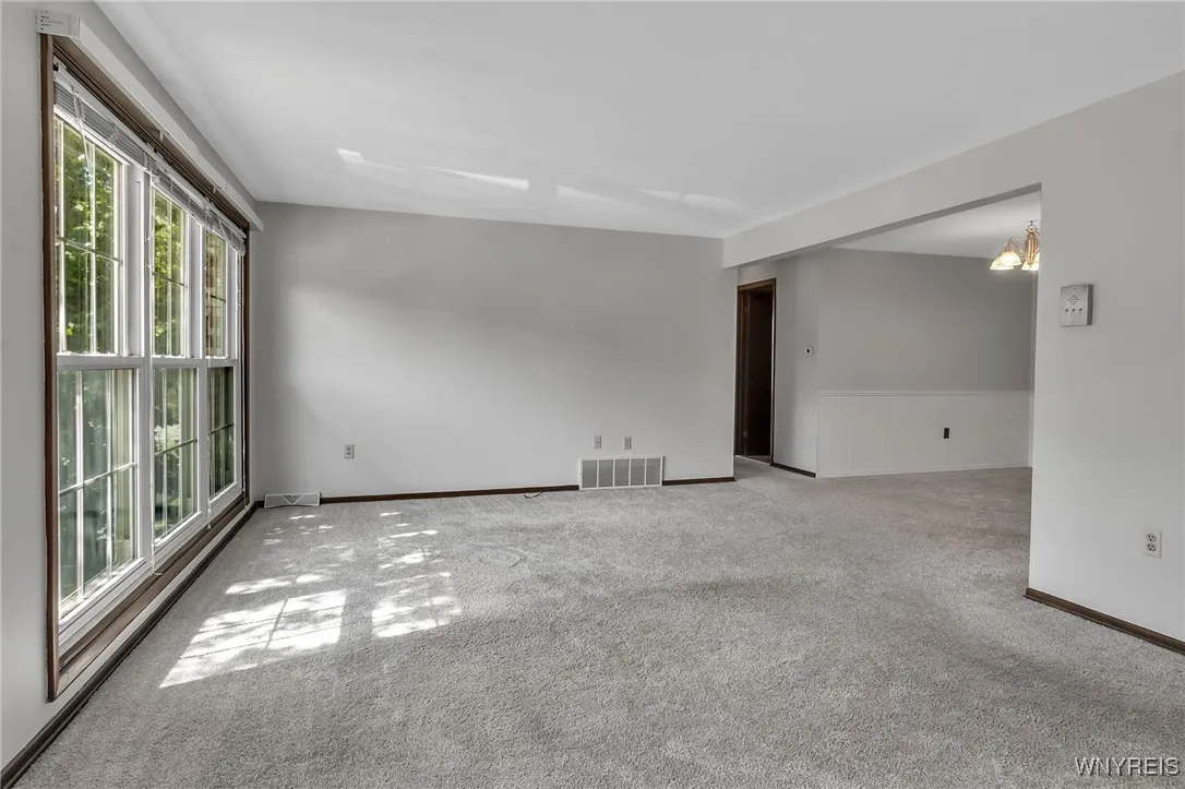 Large living room, large windows with lots of natural light