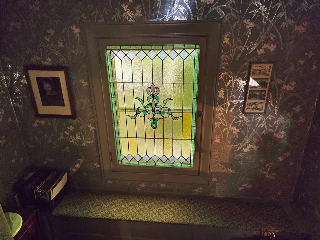 The landing has long window seat and a stained glass window (that opens).