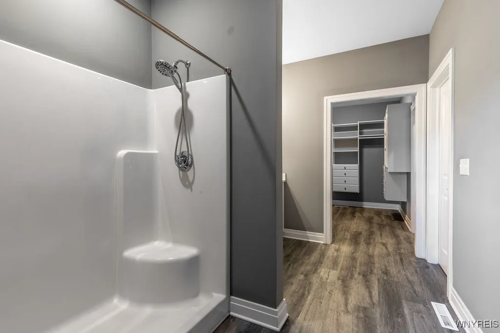 Primary bath looking into walk-in closet