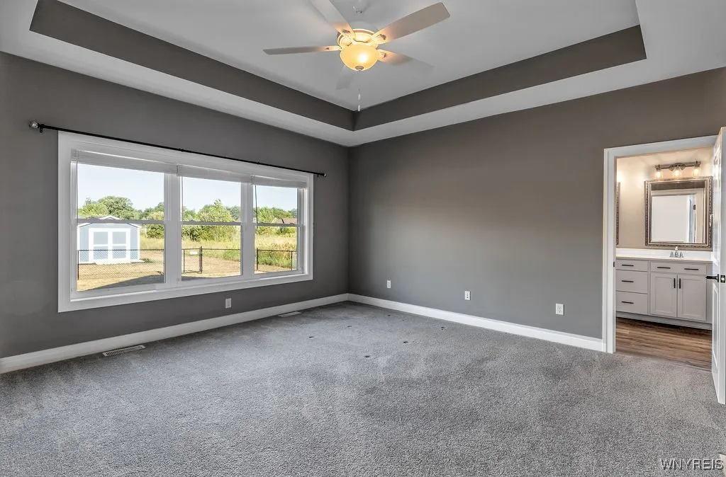 Primary suite bedroom looking towards bath
