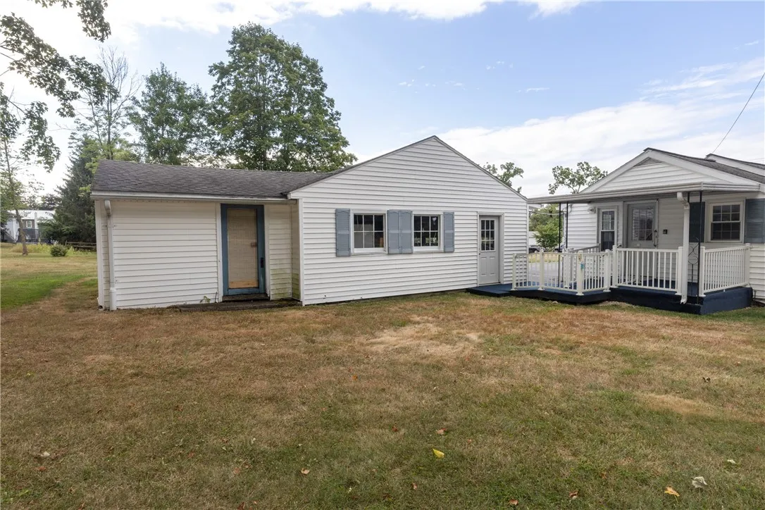 Back door entrance has a wheelchair ramp and steps. Vinyl railings and indoor outdoor carpet