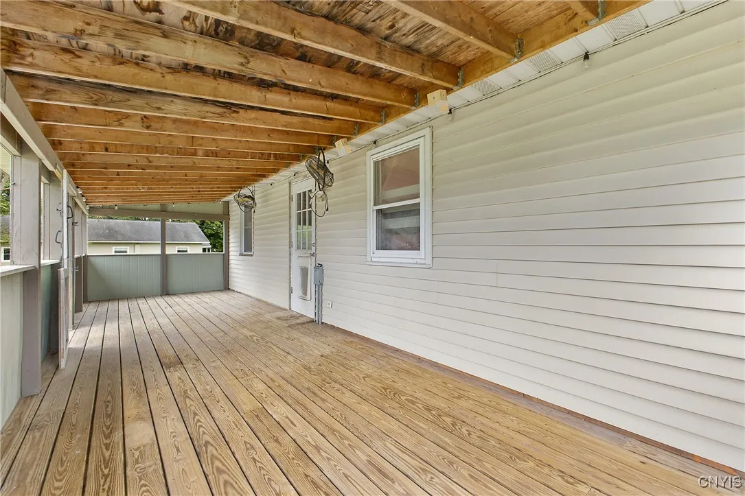 Back, covered deck measures 30X10.  There are 2 fans, mounted on 
 the right that stay.
