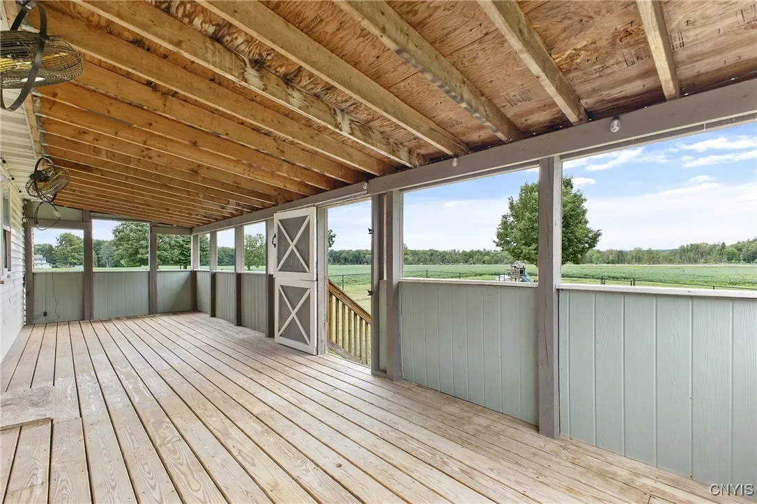 The barn-like doors can close off the deck. Stairs off the deck to the
    fully, fenced in backyard.