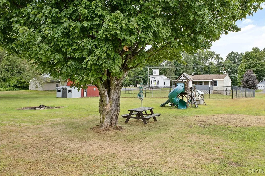 Much enjoyment will be had on the playset,  picnic table, and fire pit, 
  all staying.   The fenced area has 3 gates.