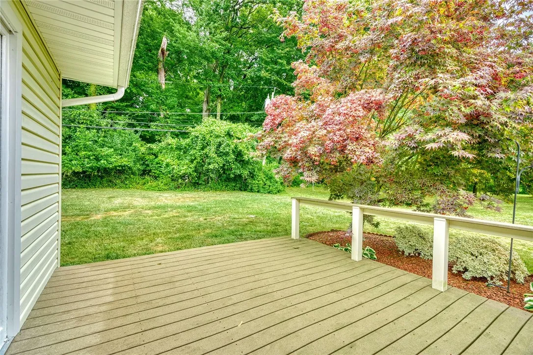 This side composite deck is tucked away and offers easy access through the sliding glass doors to the wet bar/kitchen area