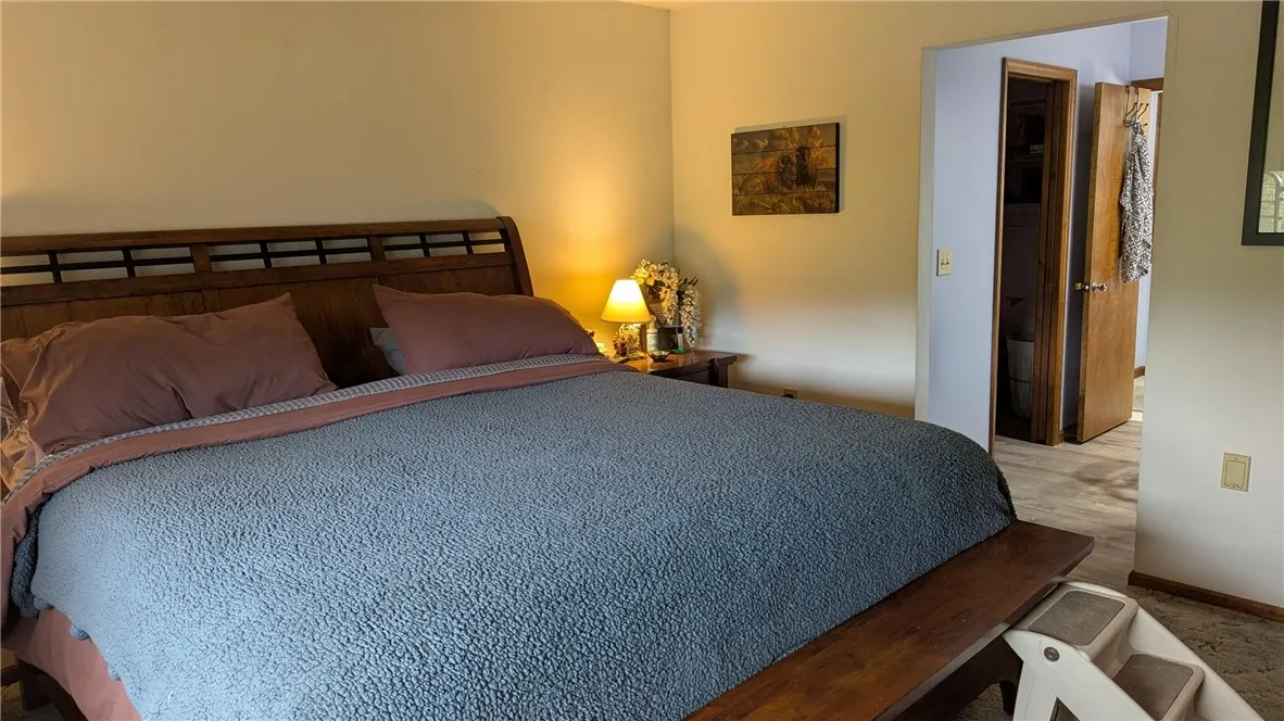 This view shows entrance to suite area with walk in closet, vanity area and full bath
